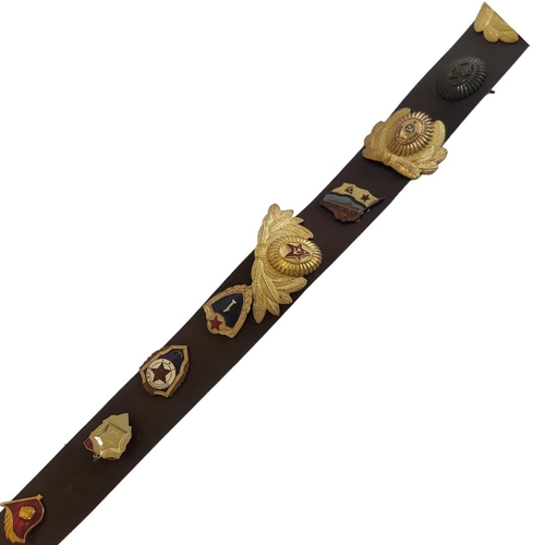 387 - A MID 20TH CENTURY RUSSIAN SOVIET MILITARY LEATHER BELT
Set with fifteen gilt metal and enamel Regim... 