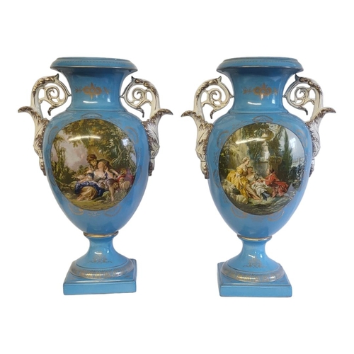 345 - A PAIR OF CONTINENTAL POTTERY VASES
Twin scrolled handles with gilt decoration,the central oval cart... 