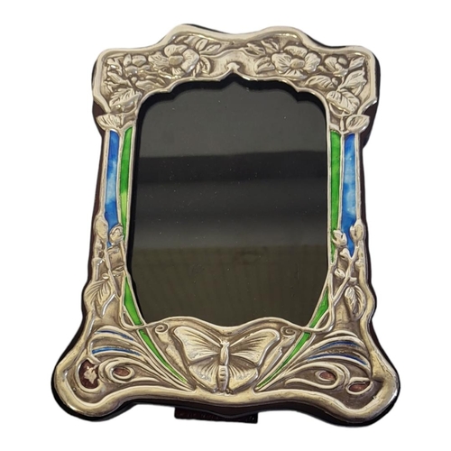 24A - AN ART NOUVEAU STYLE PICTURE FRAME
With enamel and floral embossed metal facade on a wooden easel su... 