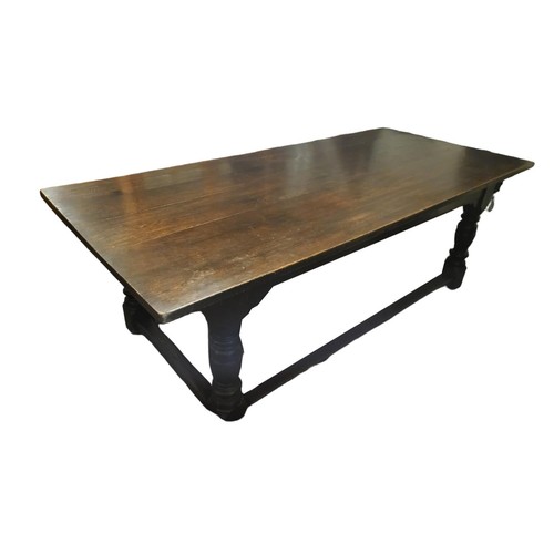 588 - A 17TH CENTURY STYLE SOLID OAK REFECTORY TABLE
The five plank top raised on four heavy turned and sq... 