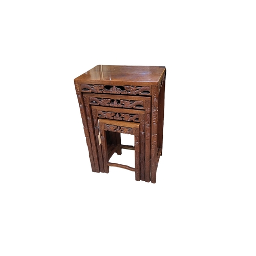 577 - AN EARLY 20TH CENTURY CHINESE HARDWOOD NEST OF TABLE FOUR TABLES
Hand carved with opposing dragons w... 