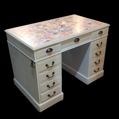 579 - AN EDWARDIAN PAINTED PINE KNEEHOLE DESK
Three drawers over two banks of four drawers, set with print... 