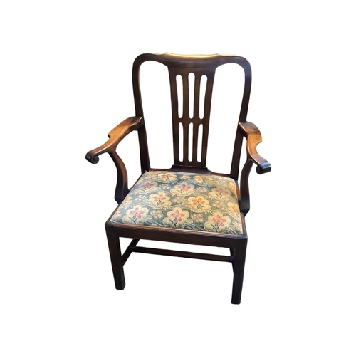 594 - AN 18TH CENTURY RED WALNUT OPEN ARMCHAIR
With pierced splat back scroll arms upholstered drop in sea... 