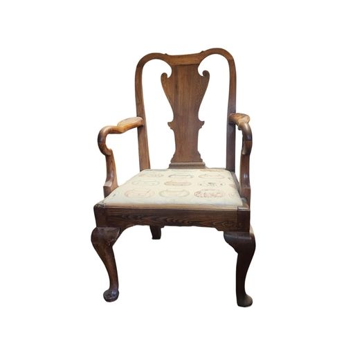 592 - A GEORGIAN OAK OPEN ARMCHAIR 
With vase back, Shepherd's crook arms and upholstered drop in seat, on... 