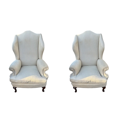 591 - A PAIR OF EARLY 20TH CENTURY GEORGIAN STYLE WING ARMCHAIRS
In oatmeal fabric upholstery with loose c... 