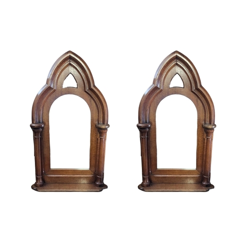 583 - A PAIR OF 19TH CENTURY GOTHIC OAK FRAMED MIRRORS
The pointed arched and central plate flanked by tur... 