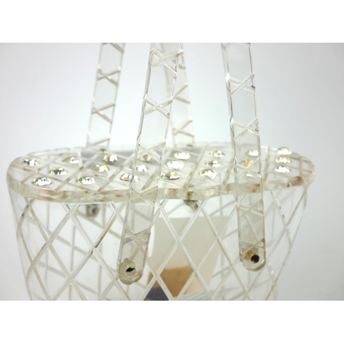 206 - A VINTAGE LUCITE AND RHINESTONE HANDBAG
Twin carry handles, set with twenty-two rhinestones within a... 