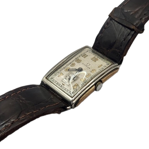 104 - OMEGA, AN EARLY 20TH CENTURY STAINLESS STEEL AND 9CT GOLD TANK GENT’S WRISTWATCH
Rectangular form wi... 