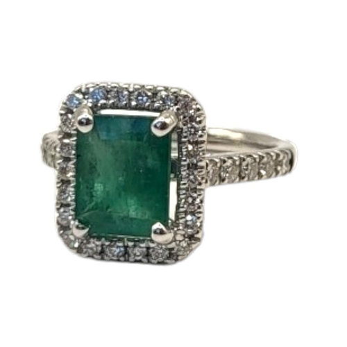 16A - AN 18CT GOLD, EMERALD AND DIAMOND RING
The central rectangular faceted emerald edged with diamonds, ... 