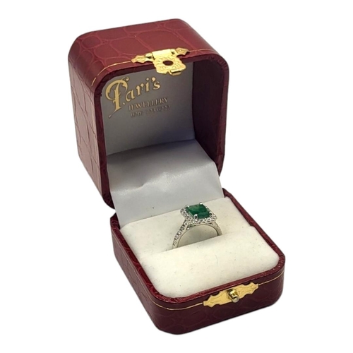 16A - AN 18CT GOLD, EMERALD AND DIAMOND RING
The central rectangular faceted emerald edged with diamonds, ... 