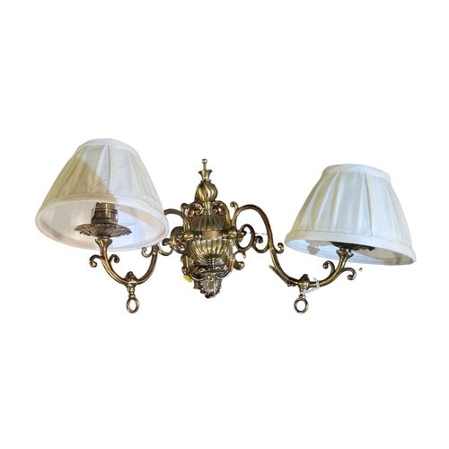 183 - A SET OF THREE 20TH CENTURY DUTCH STYLE GILT BRASS TWO BRANCH WALL SCONCES
Cast with foliate scroll ... 