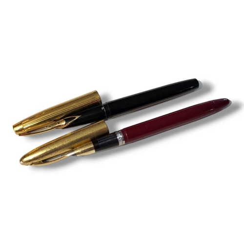 19 - SCHAEFFER, TWO VINTAGE FOUNTAIN PENS
Having gold plated mounts, black and burgundy case and 14ct gol... 