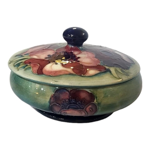 221 - MOORCROFT, A MID 20TH CENTURY POTTERY POWDER JAR AND COVER 
In anemone pattern, the body tubelined w... 