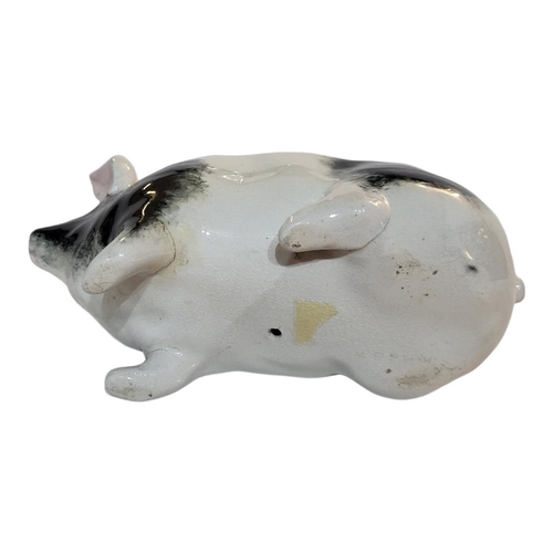 298 - WITHDRAWN AN EARLY 20TH CENTURY WEMYSS POTTERY MODEL OF A PIG
Sponged black and white decoration, Ci... 