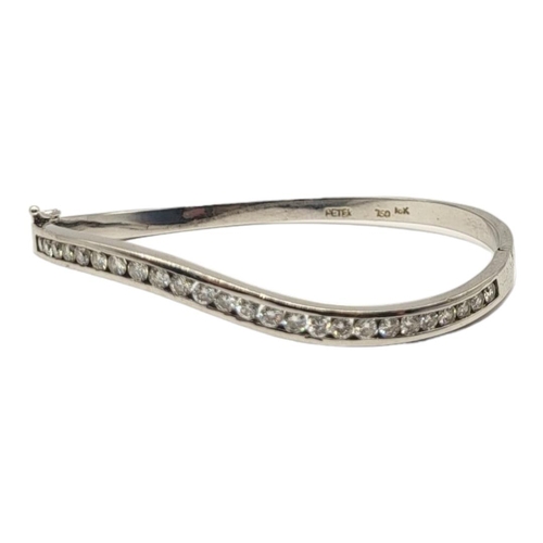 4A - PETER, AN 18CT WHITE GOLD AND DIAMOND BANGLE
The row of round cut diamonds in a wave design, marked ... 