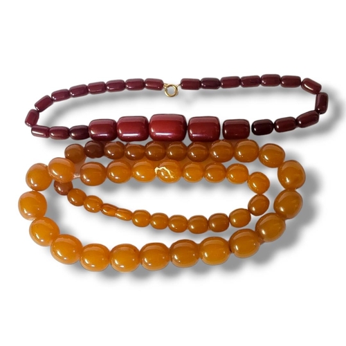 5 - A 20TH CENTURY CHERRY AMBER BEAD NECKLACE
Graduated cylindrical beads with yellow metal clasp, toget... 