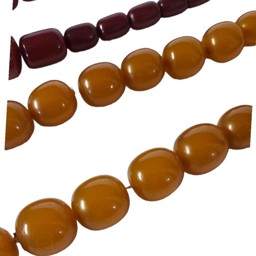 5 - A 20TH CENTURY CHERRY AMBER BEAD NECKLACE
Graduated cylindrical beads with yellow metal clasp, toget... 