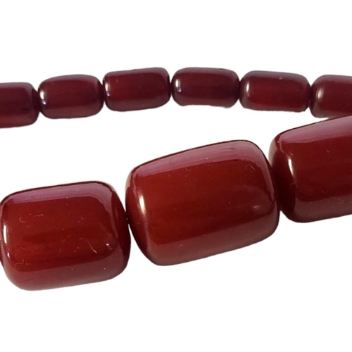 5 - A 20TH CENTURY CHERRY AMBER BEAD NECKLACE
Graduated cylindrical beads with yellow metal clasp, toget... 