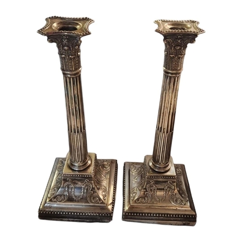 51A - A LARGE PAIR OF LATE 19TH/EARLY 20TH CENTURY SILVER CANDLESTICKS
Classical form with reede columns a... 