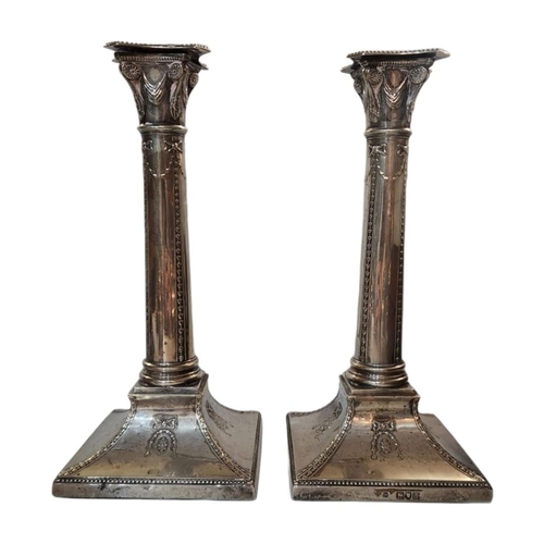 52A - A PAIR OF VICTORIAN SILVER CANDLESTICKS
Classical column form with embossed swags to base, hallmarke... 