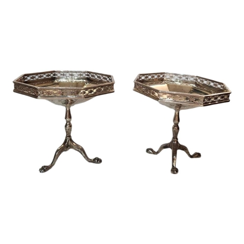 53A - A PAIR OF EARLY 20TH CENTURY SILVER OCTAGONAL SWEETMEAT DISHES
With pierced border and tripod legs, ... 