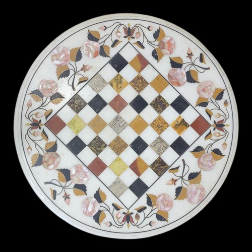 540 - AN INDIAN PARCHIN KARI WHITE MARBLE AND FLORAL INLAID CHESS TABLE TOP
Raised on a painted cast alumi... 