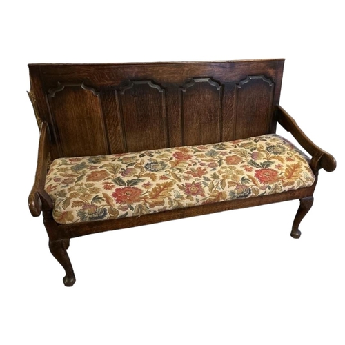 570 - AN 18TH CENTURY OPEN ARM OAK SETTLE
With four ogee panelled back, floral tapestry upholstered loose ... 