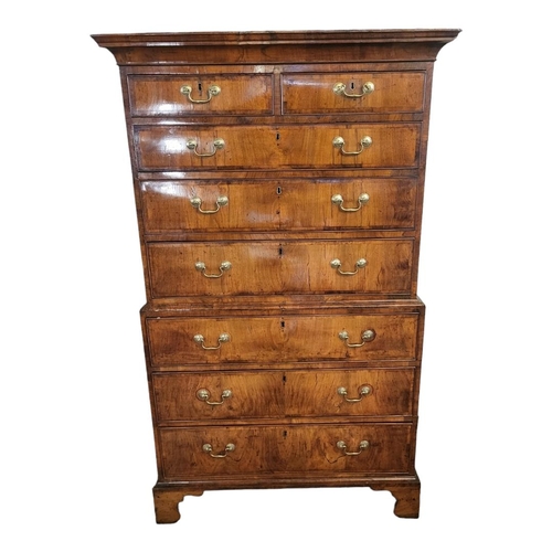 580 - AN 18TH CENTURY WALNUT CHEST ON CHEST
The deep cushion cornice above two short and six long graduati... 