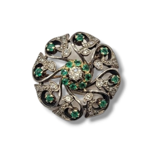 5A - A VINTAGE YELLOW METAL AND GEM SET BROOCH
The central round cut diamond,edged with green stones on a... 