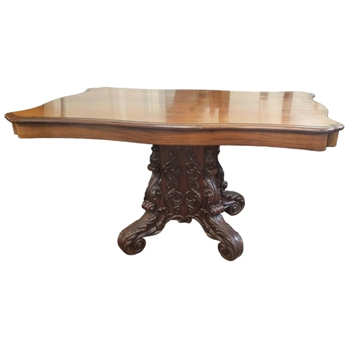 606 - A 19TH CENTURY MAHOGANY DINING TABLE
With cartouche top, raised on a heavily carved pedestal, with f... 