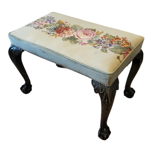 609 - AN EARLY 20TH CENTURY GEORGIAN STYLE MAHOGANY STOOL
Floral overstuffed tapestry upholstery, raised o... 