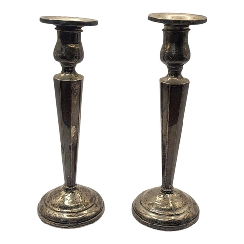 65 - A PAIR OF EARLY 20TH CENTURY STERLING SILVER CANDLESTICKS
Having tapering fluted column supports and... 