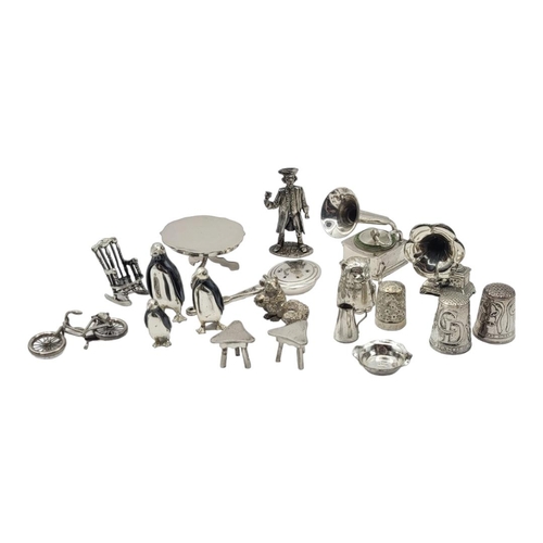 8 - A COLLECTION OF CONTINENTAL SILVER AND WHITE METAL MINIATURE TRINKETS
Comprising a town crier, rocki... 