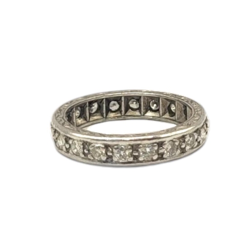 9A - A VINTAGE WHITE METAL AND DIAMOND ETERNITY RING
The single row of round cut diamonds in an engraver ... 