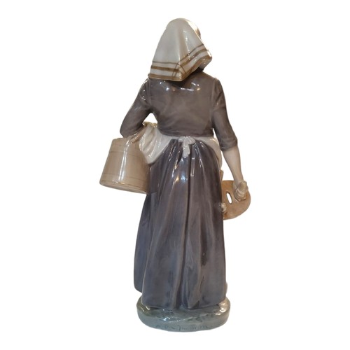 195A - CHRISTIAN THOMPSON FOR ROYAL COPENHAGEN, A HARD PASTE PORCELAIN FIGURE OF A DUTCH FARMER WOMAN, CIRC... 