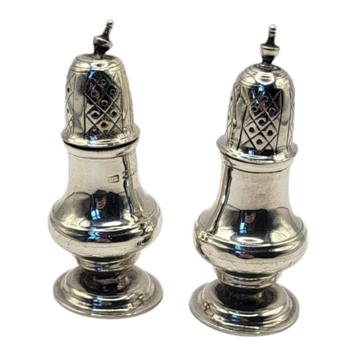 49 - A PAIR OF EDWARDIAN SILVER PEPPERETTES
Having pierced dome finials, hallmarked Sheffield, 1904.
(app... 