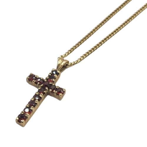 69 - A VINTAGE 9CT GOLD AND GARNET CRUCIFIX PENDANT NECKLACE
A single rows of round cut garnets, on a fin... 