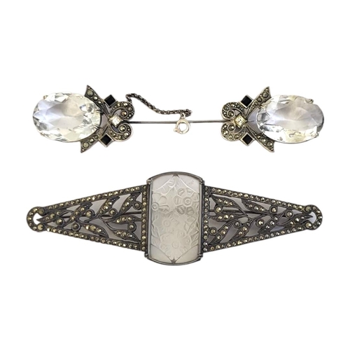 67 - AN ART DECO WHITE METAL, MARCASITE AND FROSTED GLASS BROOCH
The central floral panel set in a triang... 