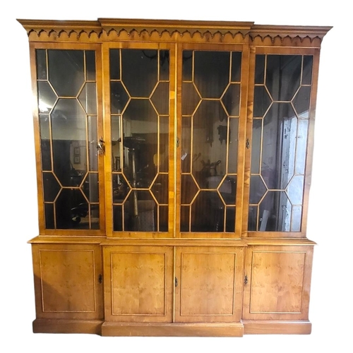 584 - A 19TH CENTURY STYLE YEW BREAKFRONT WING BOOKCASE
With four astragal glazed doors above cupboards.
(... 