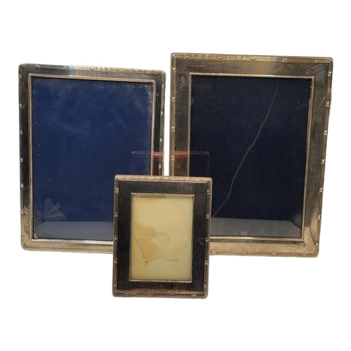 11 - A COLLECTION OF FOUR SILVER PHOTOGRAPH FRAMES
Graduated set with reeded border and easel backs, hall... 