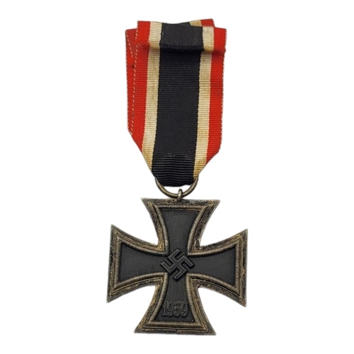 36 - A WWII GERMAN IRON CROSS MEDAL
Marked with swastikas, dated 1813 and 1939, with black white and red ... 