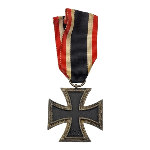 36 - A WWII GERMAN IRON CROSS MEDAL
Marked with swastikas, dated 1813 and 1939, with black white and red ... 