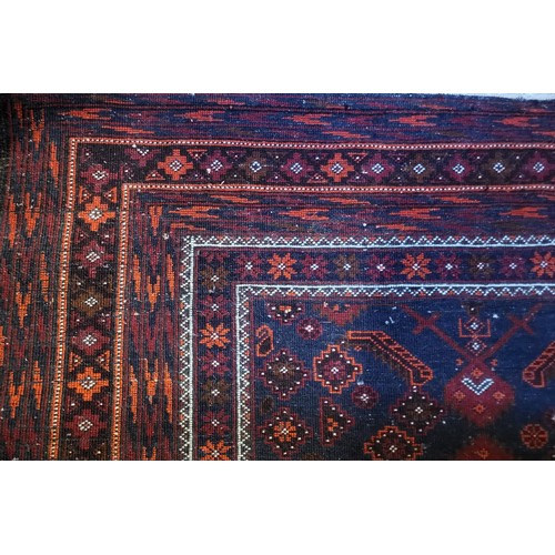 596 - A CAUCASIAN WOOLEN RUG
The central madder field within running orders.
(117cm x 214cm)

Condition: g... 