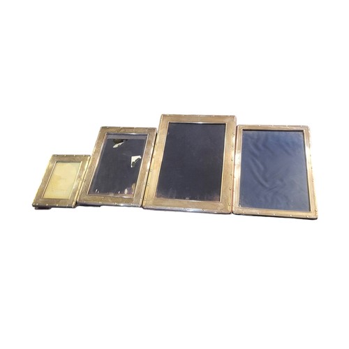 11 - A COLLECTION OF FOUR SILVER PHOTOGRAPH FRAMES
Graduated set with reeded border and easel backs, hall... 