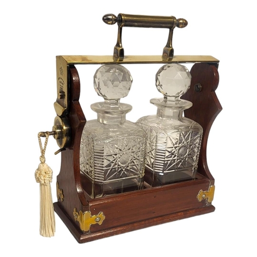 379 - BETJEMANN, A 19TH CENTURY MAHOGANY,BRASS AND CUT LEAD CRYSTAL TANTALUS
Two square decanters with cut... 