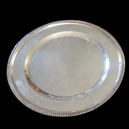 107 - A 20TH CENTURY  CONTINENTAL WHITE METAL CIRCULAR SALVER TRAY
With classical accents leaf decoration ... 