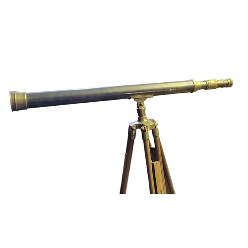 400 - A LARGE 20TH CENTURY BRASS TELESCOPE
On extending wooden tripod stand.
(approx 99cm)

Condition: goo... 