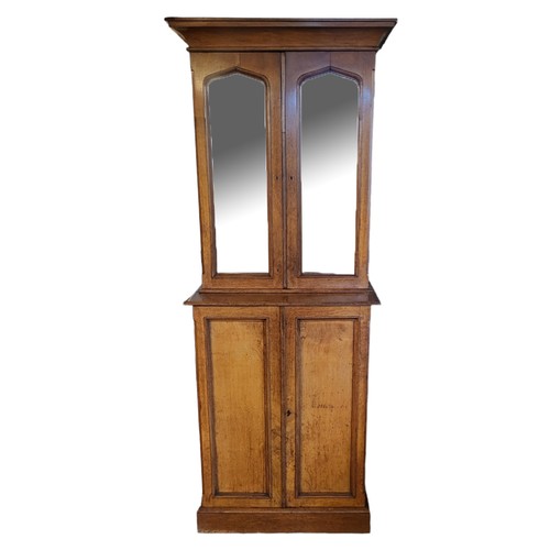 560 - A VICTORIAN HONEY OAK ESTATE CABINET
Narrow proportions, the deep cushion cornice above two Gothic p... 