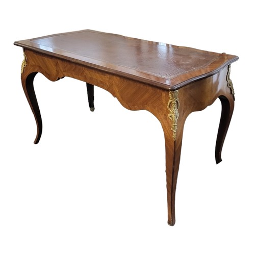 563 - AN 18TH CENTURY STYLE FRENCH MAHOGANY AND GILT METAL MOUNTED WRITING TABLE
With brown tooled leather... 