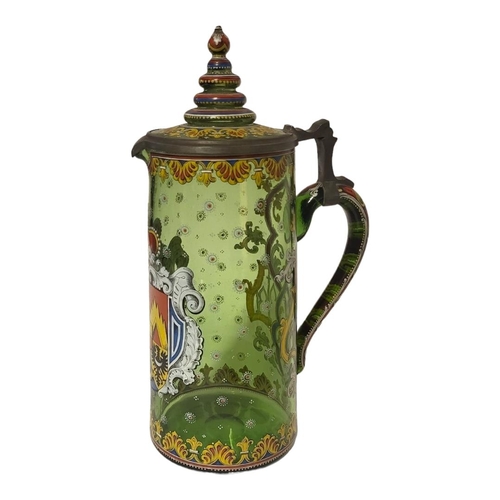 187 - A LARGE LATE 19TH/EARLY 20TH CENTURY AUSTRIAN GREEN GLASS AND ENAMEL ARMORIAL TANKARD 
Having a sing... 